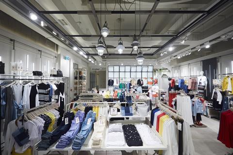 Another change of pace is made in this part of the shop by a switch to larger, plain, light-grey floor tiles, the colour of which is mirrored by an overhead wooden lighting gantry